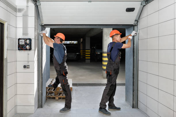 Workers are installing lifting gates of the garage.